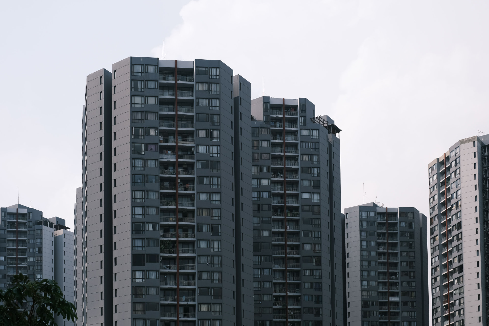A mature, established condominium surrounded by grown trees in Singapore.