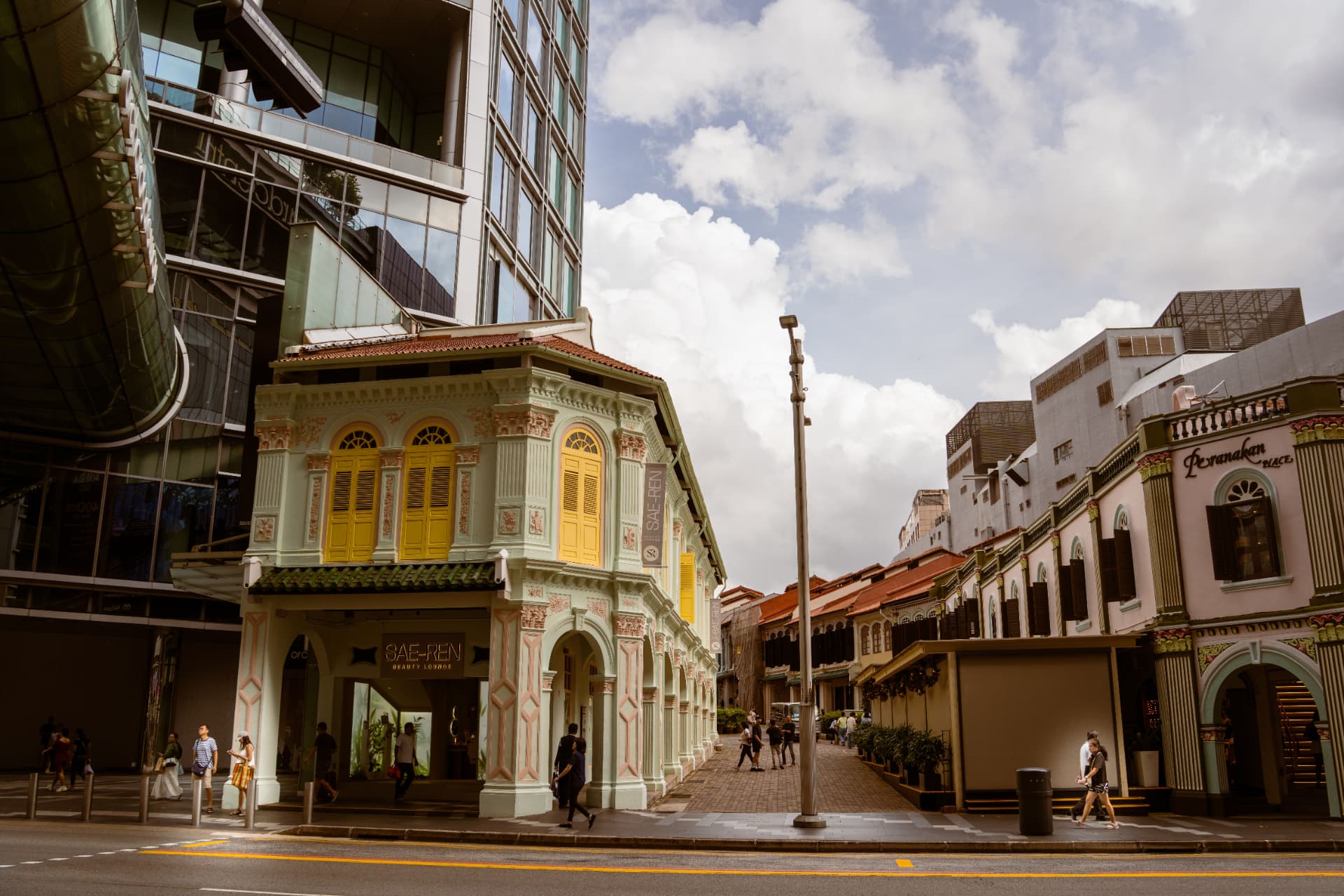 A row of conserved Singapore shophouses with traditional facades.