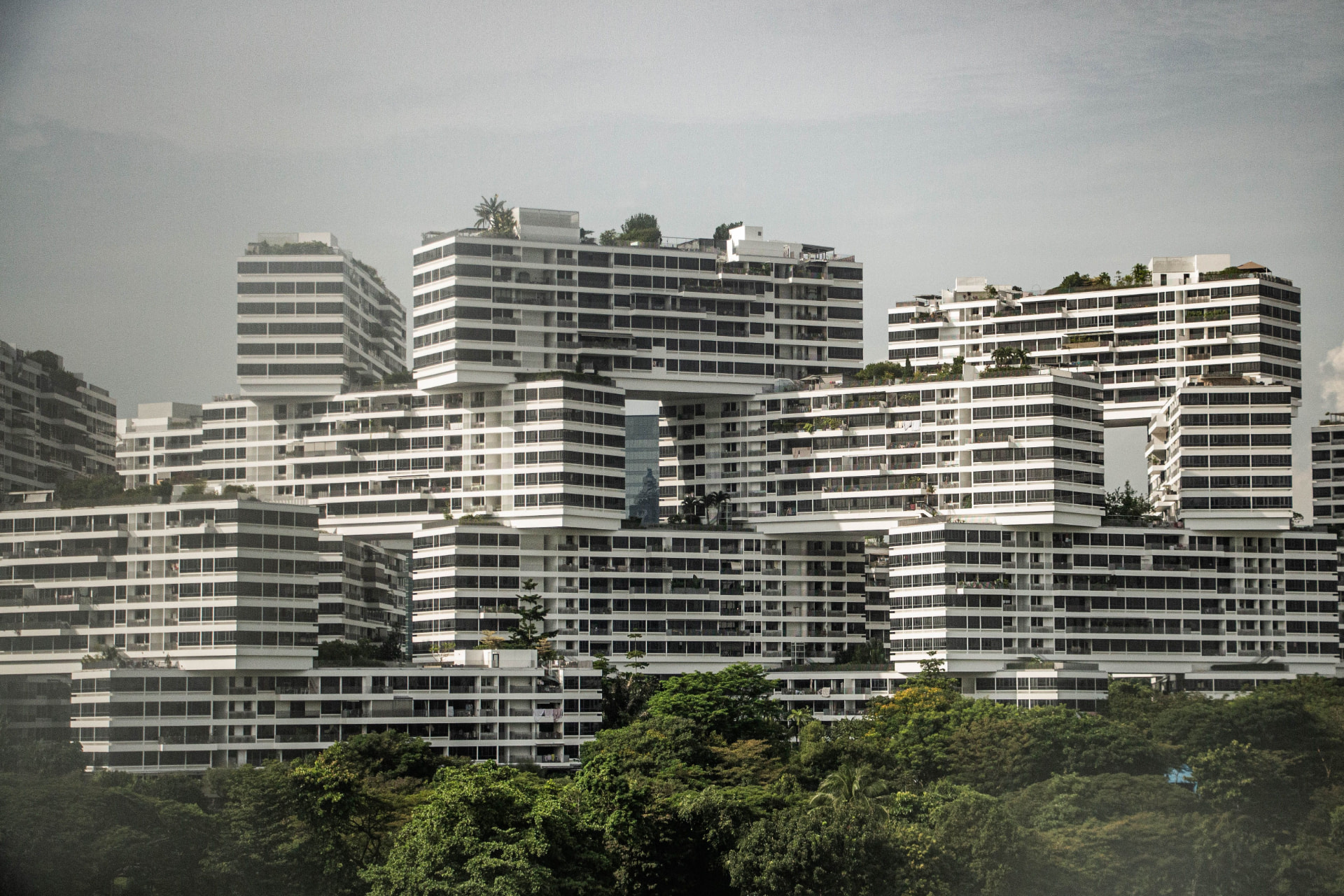 An HDB block and private condominiums in the same Singapore skyline.