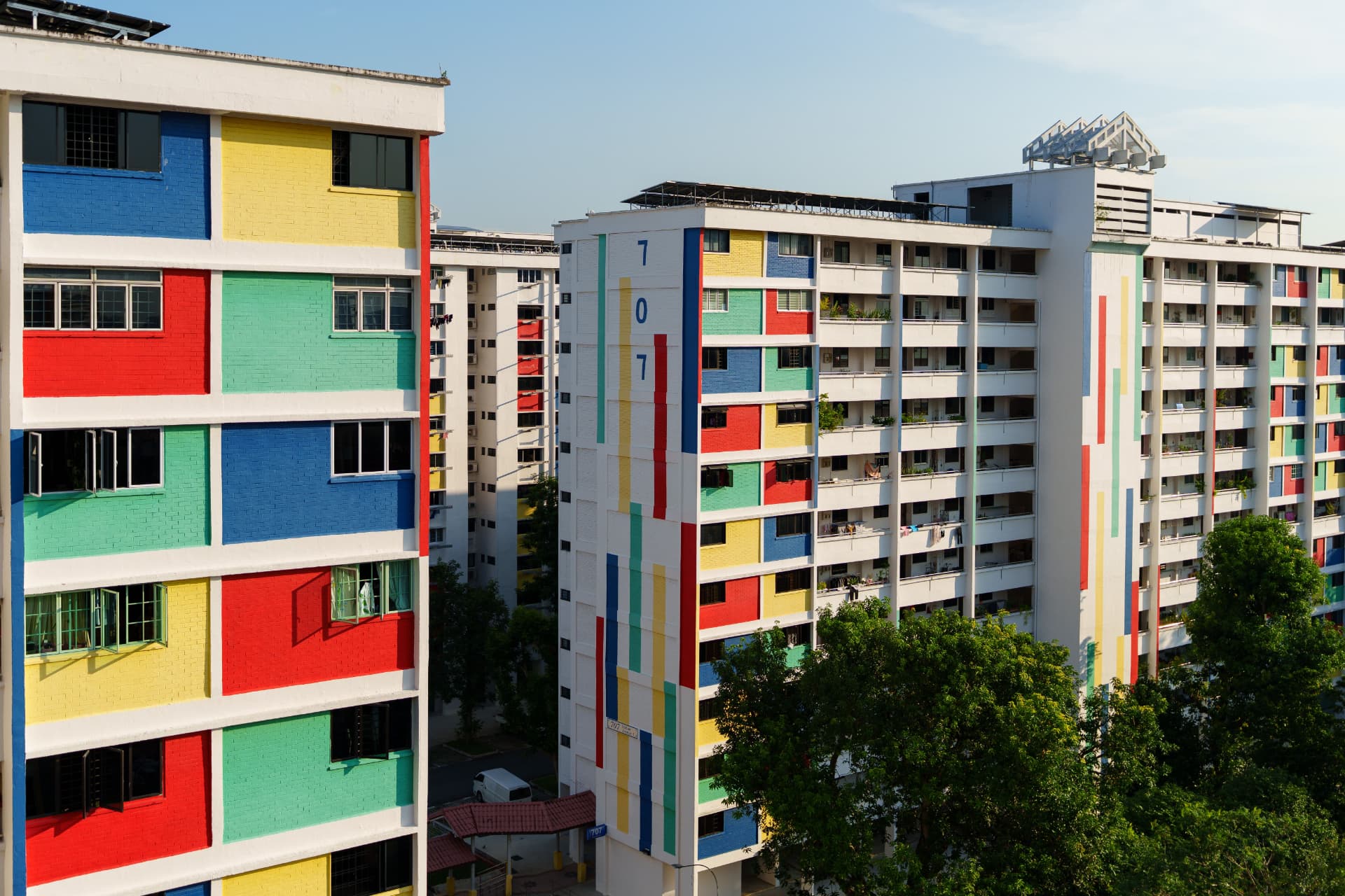 An HDB flat and a private condominium side by side in Singapore.